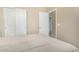 Bedroom features carpet, neutral walls, a closet, and a door leading to an adjacent room at 10583 S 175Th Ave, Goodyear, AZ 85338