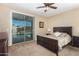 Relaxing bedroom featuring neutral walls, carpet, and sliding glass doors to the sparkling pool at 10583 S 175Th Ave, Goodyear, AZ 85338