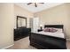 Cozy bedroom features carpet, neutral walls, a ceiling fan, and an adjoining bathroom at 10583 S 175Th Ave, Goodyear, AZ 85338