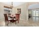 Cozy dining area with views of backyard, great natural lighting, and stylish chandelier at 10583 S 175Th Ave, Goodyear, AZ 85338