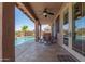 A covered outdoor patio offers a perfect seating area with a view of the sparkling pool at 10583 S 175Th Ave, Goodyear, AZ 85338