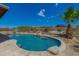 Resort-style pool surrounded by desert landscaping and serene views in a private backyard at 10583 S 175Th Ave, Goodyear, AZ 85338