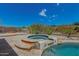 A relaxing spa with a waterfall feature and a backyard firepit at 10583 S 175Th Ave, Goodyear, AZ 85338