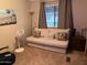 Relaxing bedroom featuring a futon sofa, neutral tones, and soft lighting at 11596 W Sierra Dawn Blvd # 209, Surprise, AZ 85378