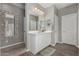 Bright bathroom featuring a decorative mirror, white vanity with wood-look tile flooring at 12143 W Marguerite Ave, Avondale, AZ 85323