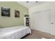 Neutral toned bedroom with twin bed and white closet with sliding doors at 12143 W Marguerite Ave, Avondale, AZ 85323