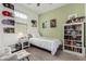 Bright bedroom featuring a twin bed, and bookcase with seating area at 12143 W Marguerite Ave, Avondale, AZ 85323