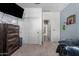 Bedroom featuring a dresser with a TV, closet with sliding doors and basketball hoop at 12143 W Marguerite Ave, Avondale, AZ 85323