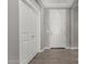 Inviting entryway features neutral walls, wood-look tile flooring, and closet for storage at 12143 W Marguerite Ave, Avondale, AZ 85323