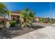 Landscaped house with desert landscaping in the front yard and covered porch with brick pillars at 12143 W Marguerite Ave, Avondale, AZ 85323