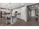 Bright kitchen with stainless appliances, center island, and sleek white cabinetry at 12143 W Marguerite Ave, Avondale, AZ 85323