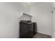 Functional laundry room equipped with modern washer and dryer units and shelf at 12143 W Marguerite Ave, Avondale, AZ 85323