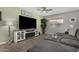 Inviting living room features modern entertainment center and stylish gray sectional sofa at 12143 W Marguerite Ave, Avondale, AZ 85323