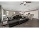 Open-concept living area with plush sectional sofa, flowing into kitchen and dining at 12143 W Marguerite Ave, Avondale, AZ 85323