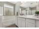 Bright bathroom features white cabinetry, a soaking tub, and soft natural light at 12143 W Marguerite Ave, Avondale, AZ 85323