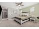 Bright bedroom featuring a ceiling fan, nightstands, and natural light from windows at 12143 W Marguerite Ave, Avondale, AZ 85323