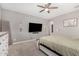 Main bedroom featuring ceiling fan, dresser, mounted TV and soft, neutral colors at 12143 W Marguerite Ave, Avondale, AZ 85323