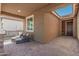 Covered patio space featuring neutral tones with brick flooring and comfortable seating at 12143 W Marguerite Ave, Avondale, AZ 85323