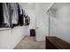 Walk-in closet with clothes hanging from the rods and a wicker chest on the floor at 12143 W Marguerite Ave, Avondale, AZ 85323