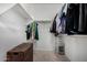 Walk-in closet featuring upper shelves with stored clothes and wicker chest at 12143 W Marguerite Ave, Avondale, AZ 85323