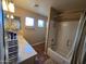 Neutral-toned bathroom featuring tile flooring, a shower-tub combo, and a vanity with excellent storage at 12237 W Sherman St, Avondale, AZ 85323
