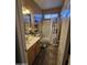 Well-lit bathroom with a vanity, framed mirror, coordinated fixtures, and a shower-tub combination with curtain at 12237 W Sherman St, Avondale, AZ 85323