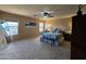 Bright bedroom with neutral paint, soft carpet, ceiling fan, and multiple windows providing ample natural light at 12237 W Sherman St, Avondale, AZ 85323