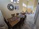 Dining area featuring a chandelier, wall decor, and views into the living room at 12237 W Sherman St, Avondale, AZ 85323