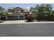 Two-story home with a three car garage, mature landscaping, and neutral colored paint at 12237 W Sherman St, Avondale, AZ 85323