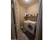 Functional laundry room equipped with a washer, dryer, and built-in shelving for storage and easy organization at 12237 W Sherman St, Avondale, AZ 85323
