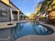 Backyard pool area complete with desert landscaping, a covered patio, and a slide for added fun at 12237 W Sherman St, Avondale, AZ 85323