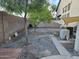 Gravel side yard featuring trees, air conditioning units, and access to the backyard at 12237 W Sherman St, Avondale, AZ 85323