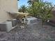 Side yard showcasing air conditioning units and other mechanics along with trees and a gravel ground cover at 12237 W Sherman St, Avondale, AZ 85323
