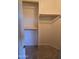 Walk-in closet featuring ample storage with shelving units and carpeted floor at 12237 W Sherman St, Avondale, AZ 85323