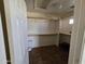Empty walk-in closet with built-in shelving and laminate flooring at 12237 W Sherman St, Avondale, AZ 85323