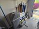Garage with water softener, filtration system, bags of salt, and cans of supplies at 12237 W Sherman St, Avondale, AZ 85323