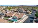 A backyard with a pool, covered patio, synthetic grass and well maintained landscaping at 1226 E Presidio Rd, Phoenix, AZ 85022