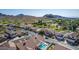 Aerial shot capturing a residential area with a neighborhood golf course and scenic mountain backdrop at 1226 E Presidio Rd, Phoenix, AZ 85022