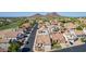 Aerial view highlighting a tile-roofed home near a lush golf course and mountain views at 1226 E Presidio Rd, Phoenix, AZ 85022