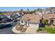 An aerial view showcasing the home, its tile roof, desert landscaping and the surrounding neighborhood at 1226 E Presidio Rd, Phoenix, AZ 85022