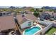 Aerial view of the backyard with a refreshing blue pool, covered patio and well maintained landscaping at 1226 E Presidio Rd, Phoenix, AZ 85022