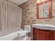 Bathroom featuring a tub and shower combination and wood cabinet sink at 1226 E Presidio Rd, Phoenix, AZ 85022