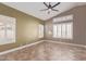 Bedroom with neutral tones, a ceiling fan, and plantation shutters allowing natural light to fill the room at 1226 E Presidio Rd, Phoenix, AZ 85022