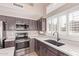 Modern kitchen featuring stainless steel appliances, a kitchen sink, and plenty of natural light from the windows at 1226 E Presidio Rd, Phoenix, AZ 85022