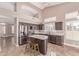 Spacious kitchen with stainless steel appliances, an island with barstools, and modern cabinetry and countertops at 1226 E Presidio Rd, Phoenix, AZ 85022
