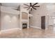 Open living room with tile floors, fireplace, designer ceiling fan, recessed lighting, and plantation shutters at 1226 E Presidio Rd, Phoenix, AZ 85022