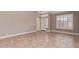 Spacious living room with tile flooring, neutral paint, plantation shutters, and modern light fixture at 1226 E Presidio Rd, Phoenix, AZ 85022