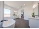 Bright bathroom featuring a soaking tub, modern fixtures, and neutral tones at 1250 E Smokehouse Trl, Phoenix, AZ 85085