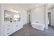 Bright bathroom with a soaking tub, white vanity, and modern fixtures at 1250 E Smokehouse Trl, Phoenix, AZ 85085