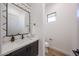 Elegant powder room featuring modern fixtures, stylish vanity with stone countertops and decorative wall tiles at 1250 E Smokehouse Trl, Phoenix, AZ 85085